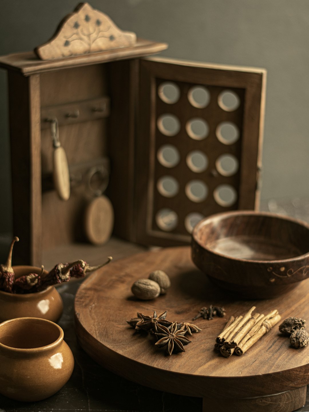 Assorted spices and herbs arranged on a wooden cutting board.