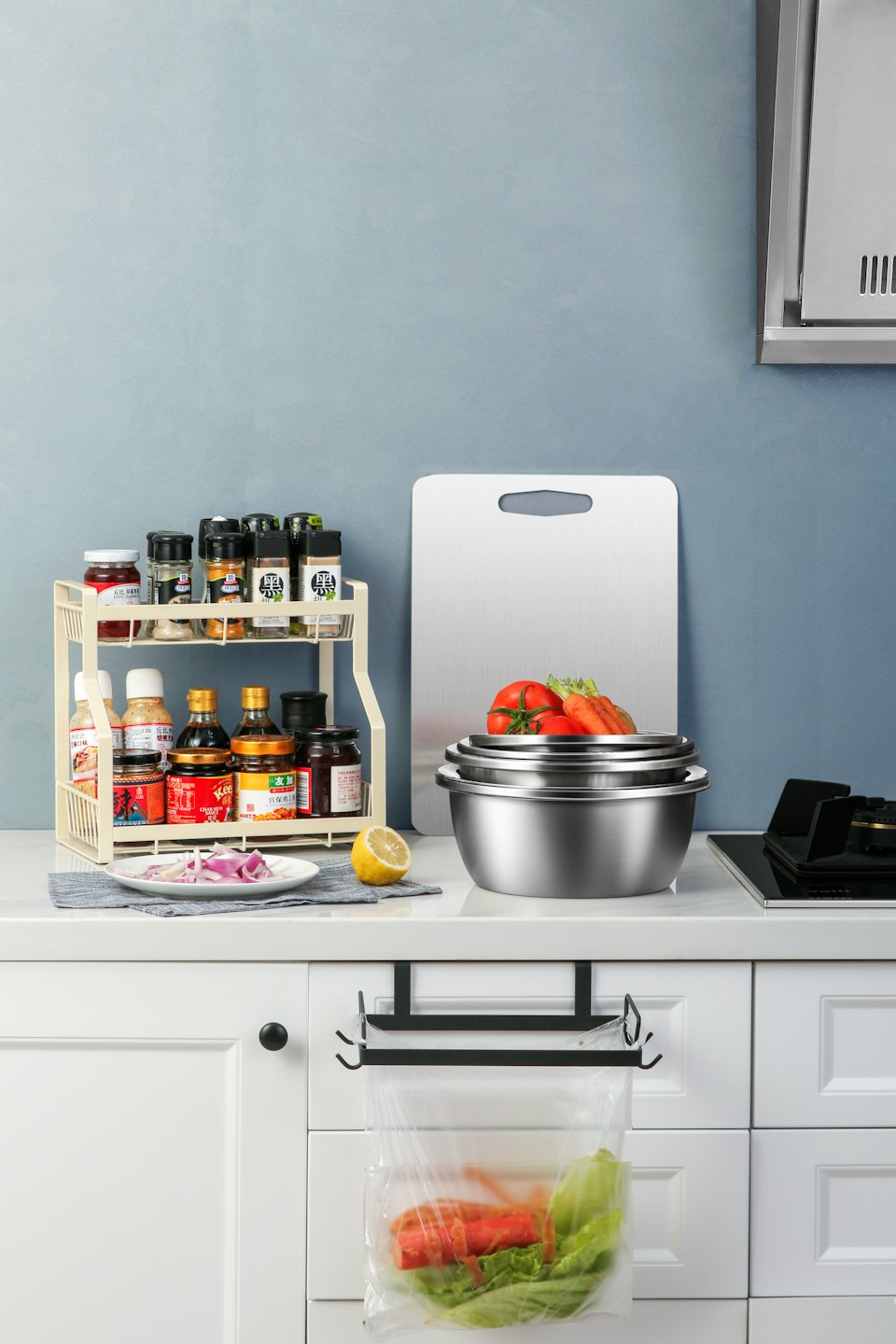 Fresh vegetables and kitchen spices rest on a modern countertop.